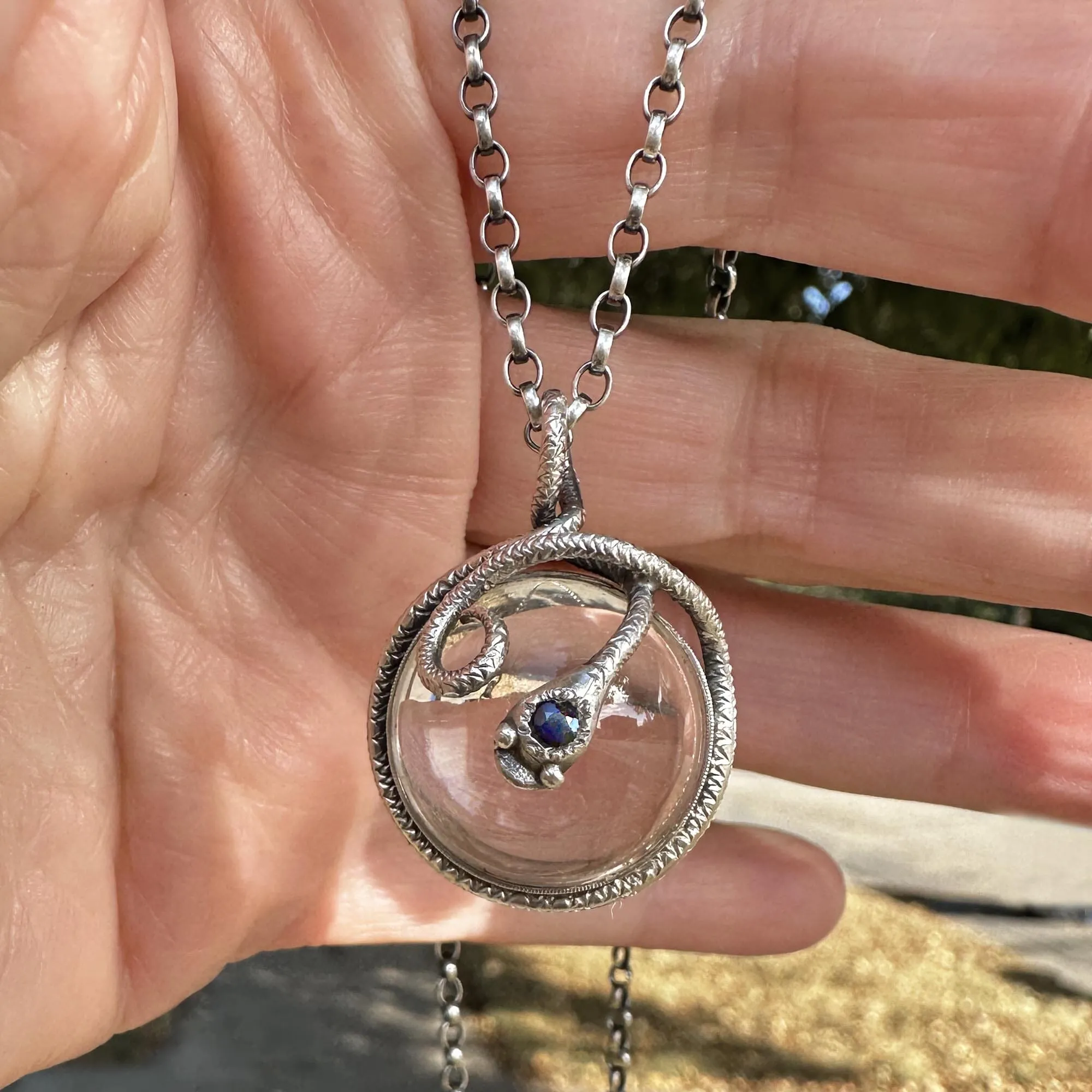 Silver Sapphire Pools of Light Rock Crystal Snake Necklace
