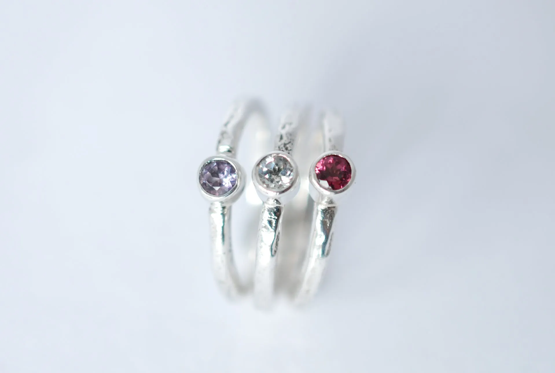 Silver stacking ring with amethyst gemstone.