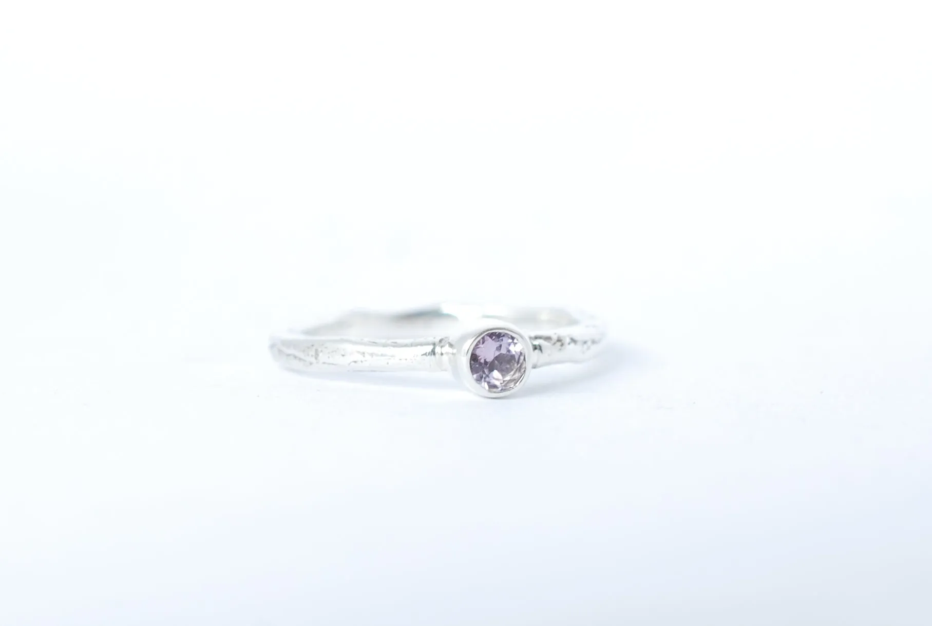 Silver stacking ring with amethyst gemstone.