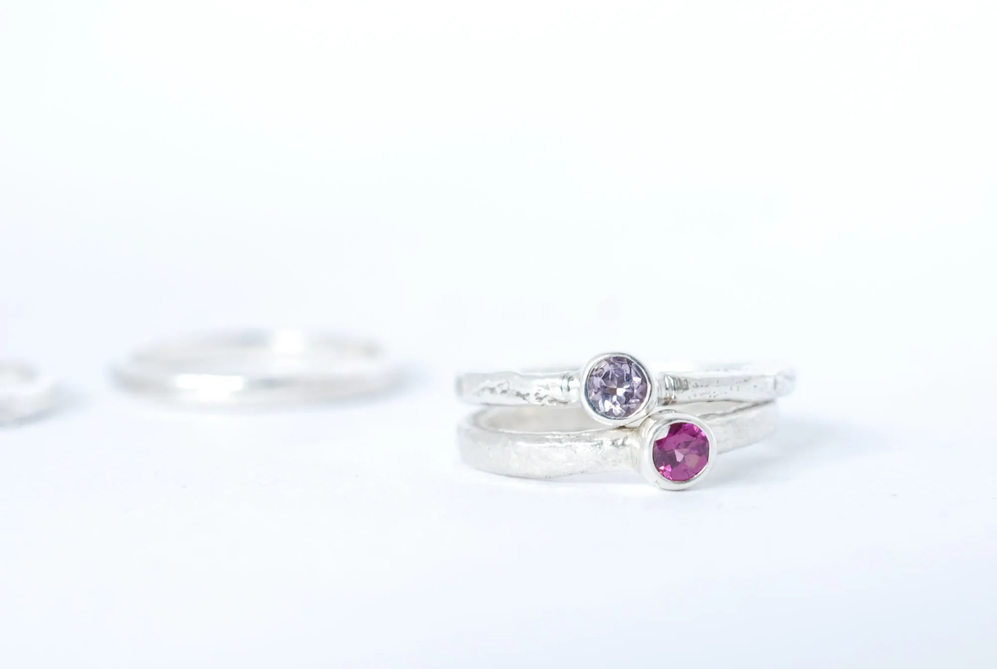 Silver stacking ring with amethyst gemstone.