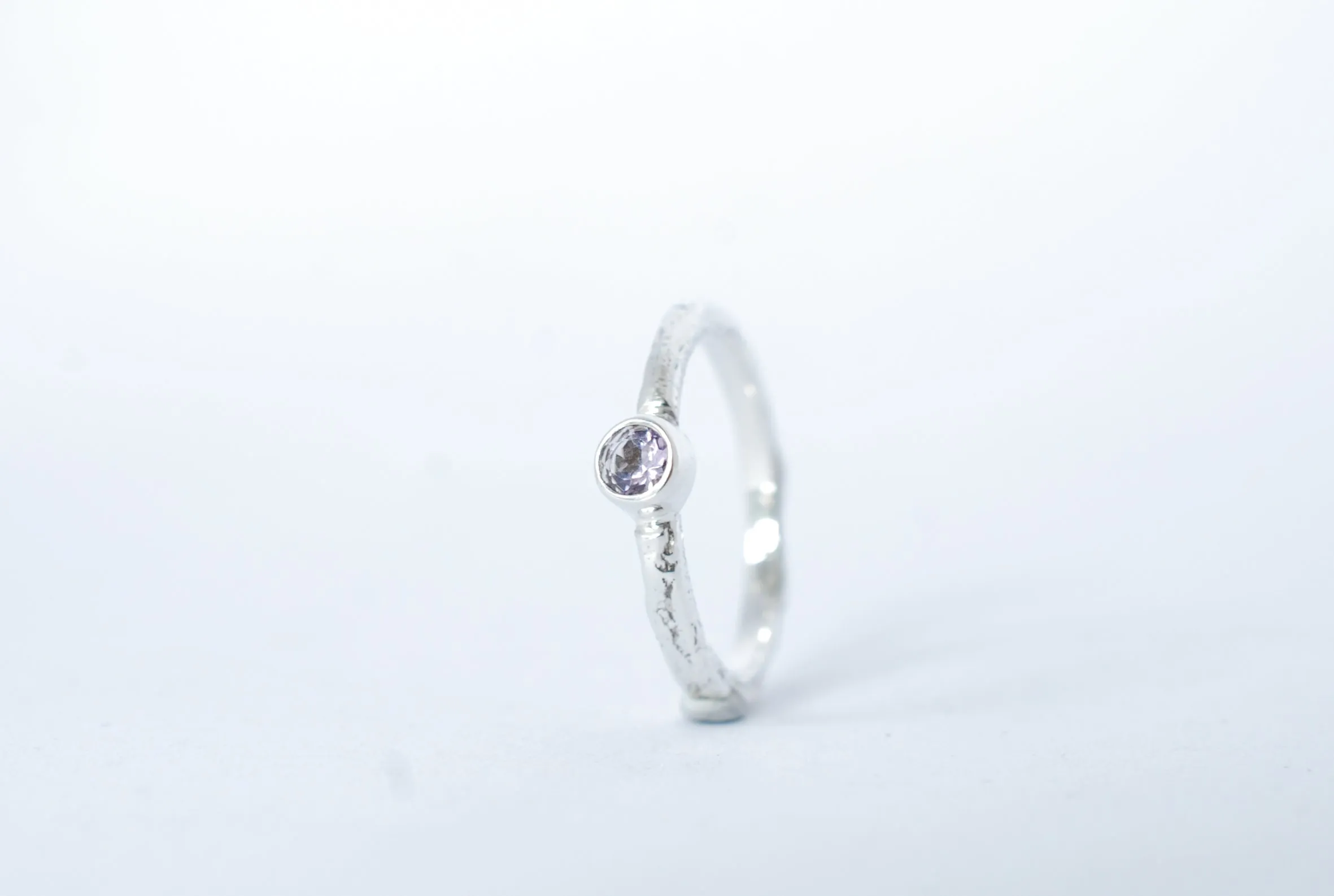Silver stacking ring with amethyst gemstone.